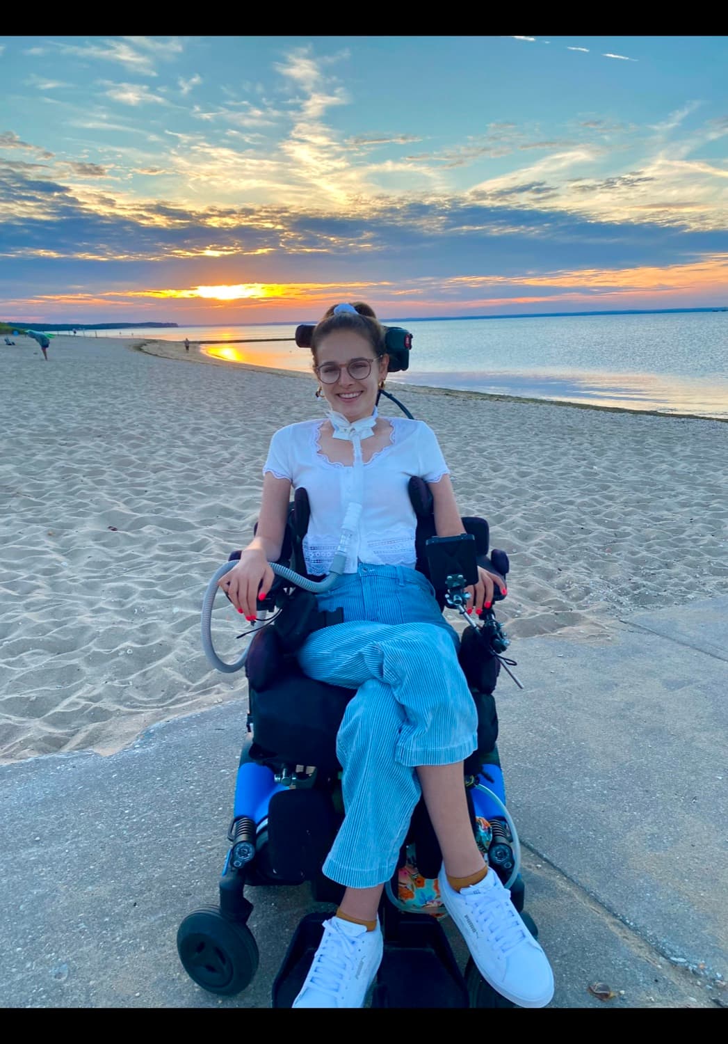 Rebecca in her wheelchair at sunset on a Long Island beach.